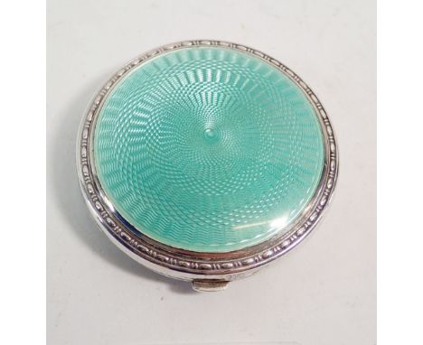 A silver and green enamel compact, 5.5cm diameter Birmingham 1929 with patent insert by Crisford &amp; Norris 