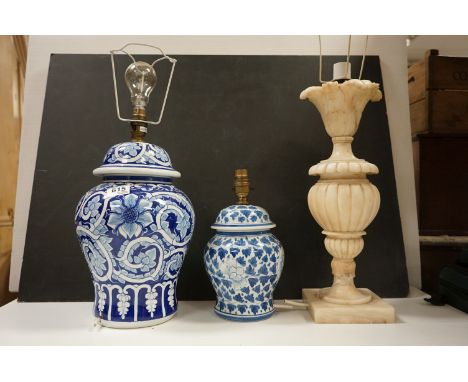 Two contemporary blue and white vase shaped table lamps together with an alabaster lamp of of reeded  classical form. 