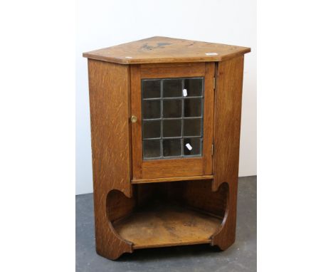 Arts and Crafts style Oak Hanging Corner Cabinet with a leaded glazed single door above an open shelf, 79cms high x 59cms wid