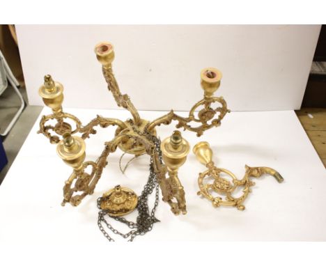 A carved wooded gilt chandelier five branch ceiling light of classical form together with spare arm. 