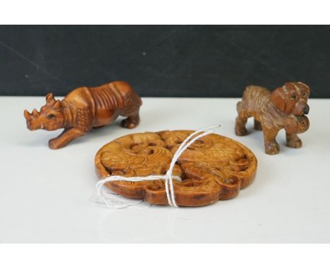 Chinese Faux Boxwood Roundel together with a Boxwood Netsuke in the form of a Rhino and a Black Forset Style Carved St Bernar