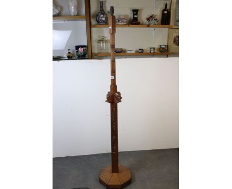 Arts and Crafts Oak Standard Lamp, the carved column including a bracket of four carved characterful faces, raised on an octa