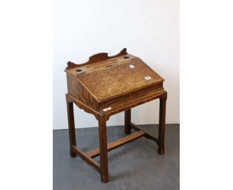 19th century Oak Child's Desk with shaped back rail and two open inkwell holes, lift up sloping writing surface, raised on sq