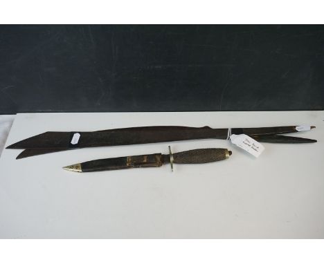 A vintage Real Knife Witness by Taylors of Sheffield with leather scabbard together with two dyak sword blades. 