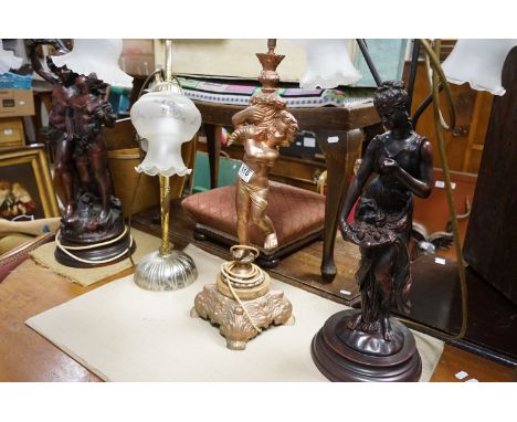 Two three branch bronzed resin lamps of classical figurative form, one other similar painted, and a brass effect twin headed 