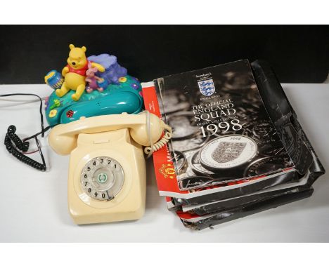A box of mixed collectables to include two vintage telephones and a selection of football memorabilia 