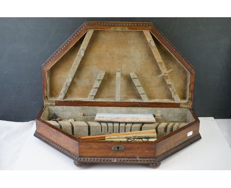 A vintage wooden cutlery box containing mixed collectables to include coins, a netsuke and a fan. 