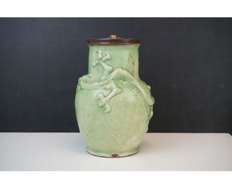 An antique green glazed pottery vase with three toed dragon decoration to the body, converted to a lamp.