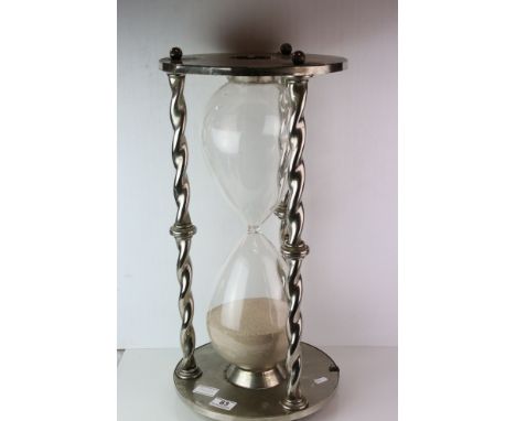 A large novelty metal and glass egg timer 