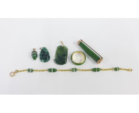 A collection of jadeite jewellery to include a 9ct gold mounted brooch, a ring stamped 14k, a carved plaque pendant on a 14ct