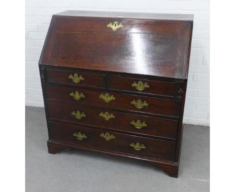 Georgian oak bureau chest, with a fall front and fitted interior over pull out slides , two short and three graduating long d