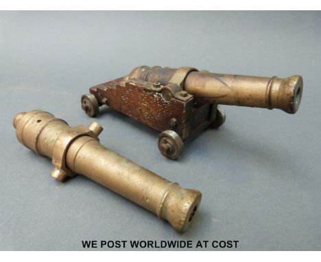 A brass and oak table or possible signalling camera on turned brass heels, together with a further brass barrel, length 17.5c