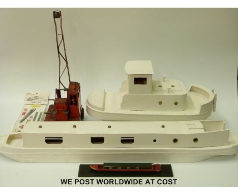 Two wooden part built model boats together with a tin-plate model crane