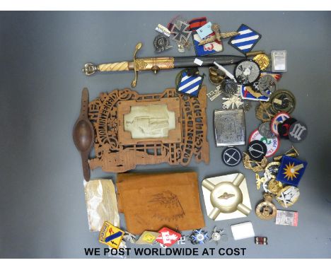 A quantity of various military badges and medals to include German, American etc, some reproduction, a fretwork WWI frame and