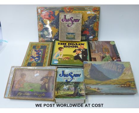 Six Chad Valley jigsaw puzzles including Imperial and International Communications Ltd world map, Aldershot Tattoo, Across th