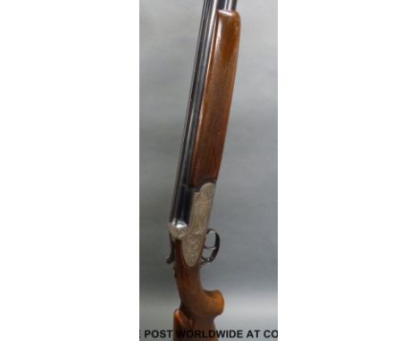 Italian 12 bore over and under shotgun with floral engraving to the locks, chequered semi-pistol grip, double trigger and ven