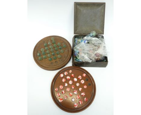 A large collection of vintage marbles and two wooden solitaire boards