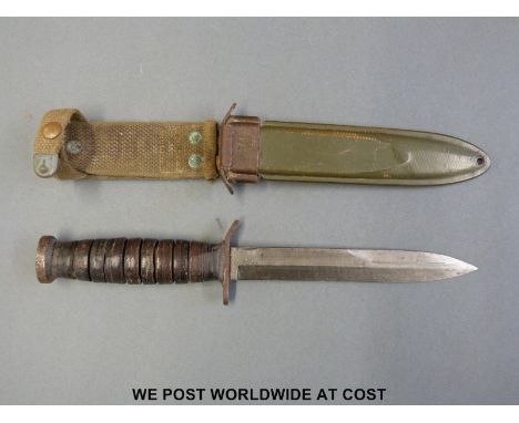 A WWII American US M3 fighting knife marked UTICA in M8 scabbard