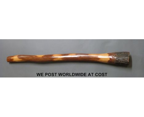 An Australian Didgeridoo 'naturally produced by termites', approximately 129cm length, bark retained at end