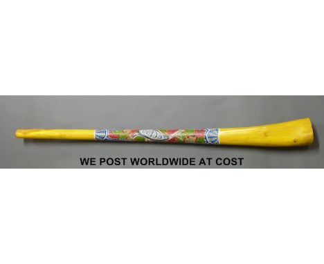 An Australian Didgeridoo with Aboriginal style bead paint decoration in the form of a dolphin, approximately 129cm length, in