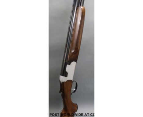 Beretta S56E 12 bore over and under shotgun with all over engraved decoration, vented top rib, chequered semi-pistol grip and
