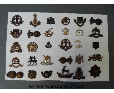 A carded display of 30 British army officer's collar badges, Middlesex Regiment, Hampshire, Cornwall, 16th Lancers, Welsh Fus