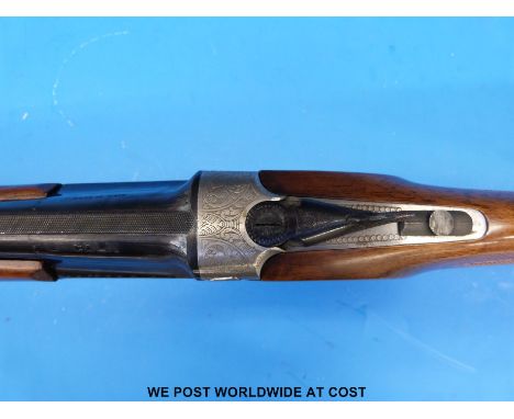 Lincoln 12 bore over and under shotgun with all over floral engraving, double trigger, chequered grip, vented top rib and 27.
