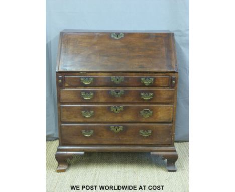 A Georgian mahogany bureau with fitted interior, secret drawer, four straight graduated drawers raised on bracket feet (W92 x