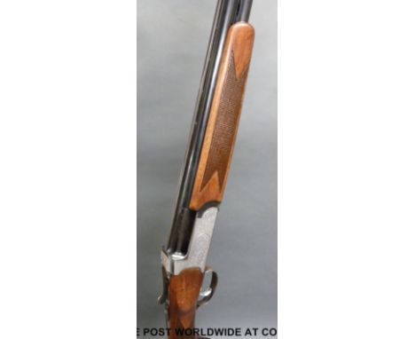 Midland Gun Company 12 bore over and under shotgun with ornate engraving, chequered grip and forend and vented top rib to the