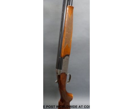 Browning Medallist 12 bore over and under shotgun with named and ornately engraved locks, chequered semi-pistol grip, gold si