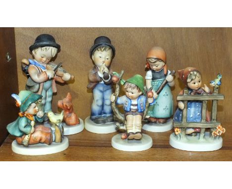 A collection of six Hummel figures: 'Puppy Love' 13cm, 'Singing Lesson' 8.5cm, 'Serenade' 13cm, 'Signs of Spring' 10cm, 'Appl