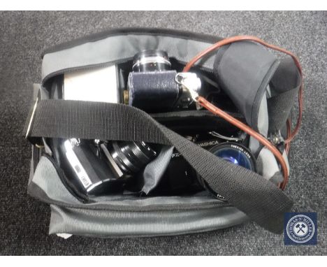 A camera bag containing Yashica SX-3, Praktica camera etc with lens and accessories 