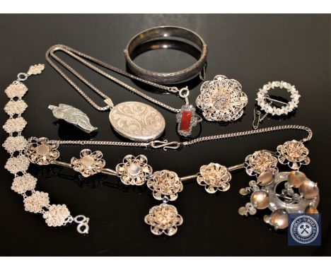 A collection of silver jewellery including locket, ring, bangle, brooches etc