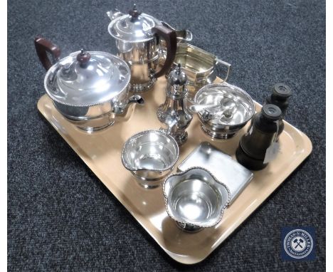 A tray containing pair of field glasses, assorted plated wares including a four-piece plated tea service, cutlery, cigarette 