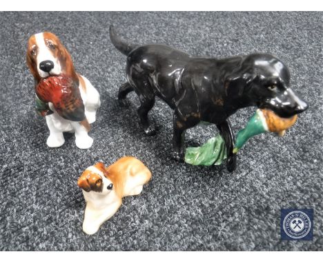 A Royal Worcester figure of a black Labrador with pheasant, together with two Royal Doulton figures, Spaniel with pheasant an