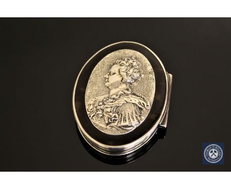 A white metal and tortoiseshell pill box with a relief portrait of Queen Anne