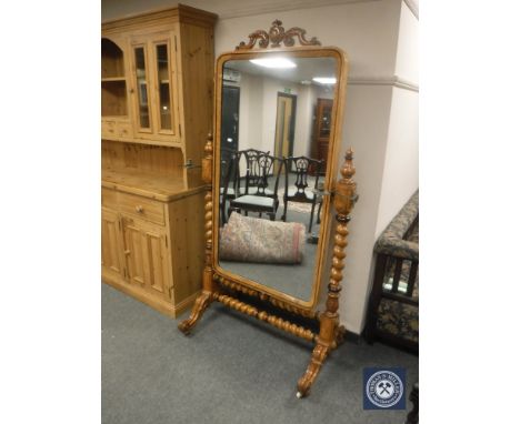 A late 19th century satinwood cheval mirror, with twin candle sconces, raised on ceramic castors, height 190 cm.