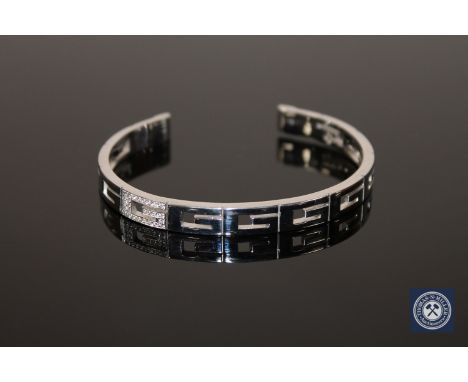 An 18ct gold diamond set bangle by Gucci, 28.2g (Cost £2,800 new) 