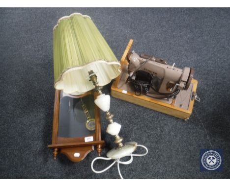 A cased vintage Singer sewing machine, pair of boxed hurricane lamps, brass and marble table lamp with shade and a Quartz wal