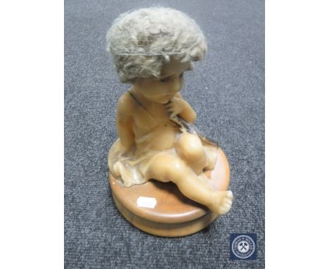 An early 20th century wooden trinket dish surmounted by a wax doll CONDITION REPORT: Appears to be in good condition. We have