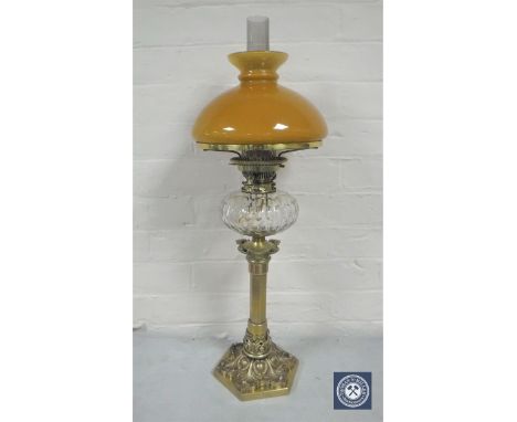 A good Victorian brass King &amp; Brown oil lamp with glass chimney and tan shade, with clear glass reservoir