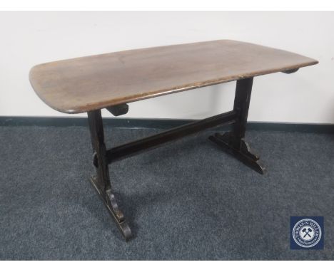 An Ercol elm refectory dining table 