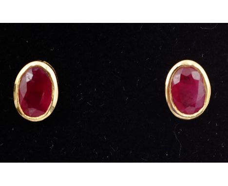 Pair of ruby gold rim set ear-studs stamped 9K   Condition Report   Click here for further images, condition, auction times &