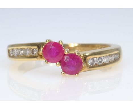 18ct gold two stone ruby and ten stone diamond ring hallmarked   Condition Report  Approx 3.9gm size M rubies 0.65 carat Clic