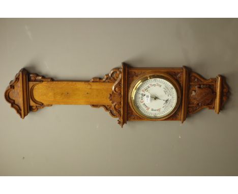 Early 20th century oak case aneroid barometer, carved scrolls with crest, H105cm    Condition Report   Click here for further