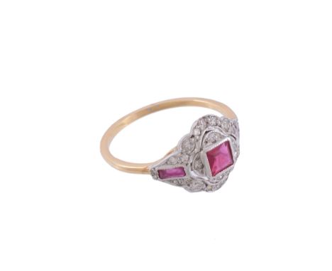  A ruby and diamond ring,   the central step cut ruby collet set within a surround of brilliant cut diamonds and two further 