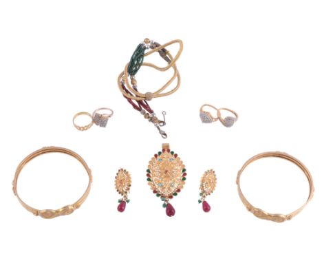  Two gold coloured bangles,   each with scrolled panel to two row backs; a pair of gold coloured ear pendants with red and gr