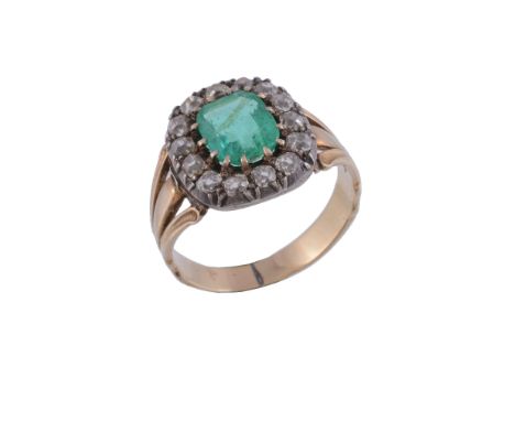  A Victorian emerald and diamond cluster ring,   the step cut emerald with canted corners within a surround of old cut diamon