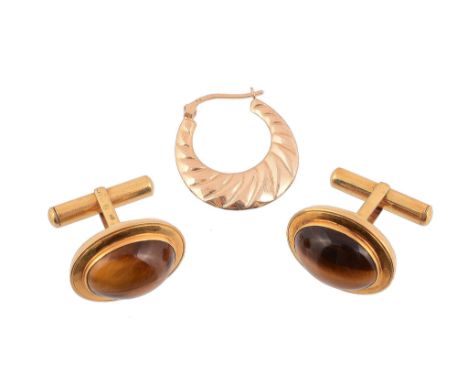  A pair of tigers eye cufflinks  , each panel with an oval cabochon tigers eye within a polished gold coloured surround, stam