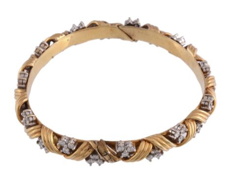  A diamond bangle,   the hinged bangle of twisted design, set with clusters of brilliant cut diamonds, to a concealed box sna